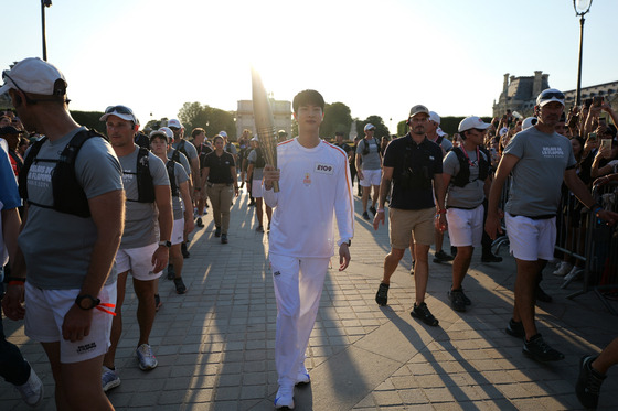 Jin waits to receive the Olympic torch in Paris on July 14. [BIGHIT MUSIC]