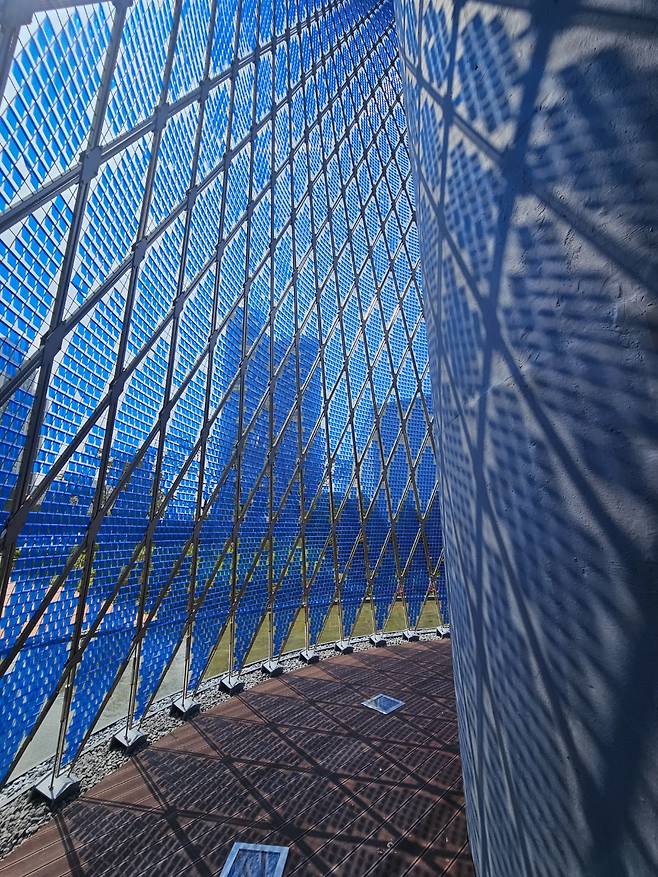 Visitors can walk inside around the existing water tower as part of “Rain Veil” by Ned Kahn. (Park Yuna/The Korea Herald)