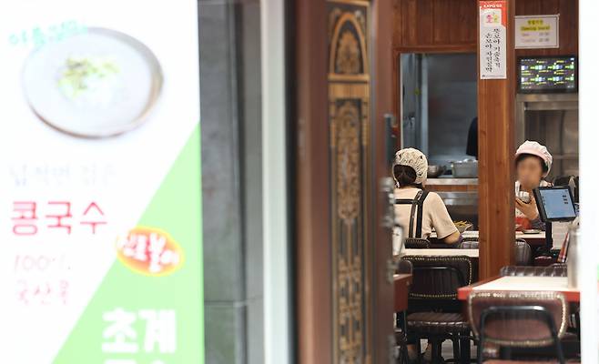 Workers are seen at a restaurant in Myeongdong, central Seoul. (Yonhap)