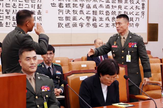 ▲19일 국회 법제사법위원회에서 열린 '윤석열 대통령 탄핵소추안 발의 요청' 국민동의 청원 청문회. 증인출석한 박상현 해병대 1사단 7여단장이 임성근 전 해병대 1사단장에게 경례하고 있다. ⓒ연합뉴스
