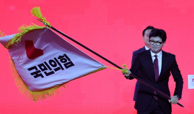 한동훈 국민의힘 대표가 23일 경기 고양시 킨텍스에서 열린 전당대회에서 당기를 흔들고 있다. 공동취재사진