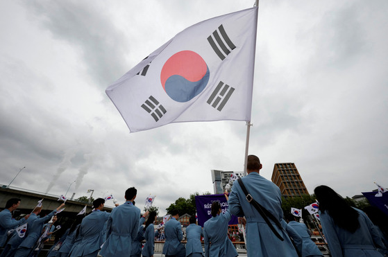 Korean athletes wave from a boat during the opening ceremony of the Paris Olympics in Paris on Friday. [REUTERS/YONHAP]