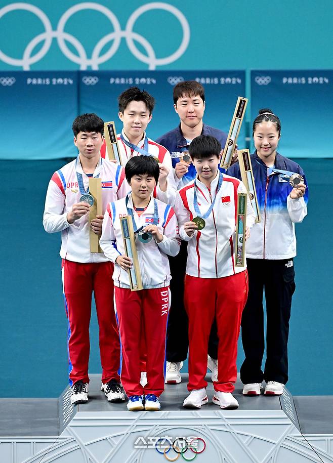 탁구 대표팀의 신유빈-임종훈 조(오른쪽)가 30일 (한국 시간) 프랑스 파리 아레나 파리 쉬드에서 열린 2024 파리올림픽 탁구 혼성 복식에서 동메달을 딴 뒤 금메달 중국 왕추친-쑨잉사, 은메달 북한 리정식-김금용과 함께 기념사진을 찍고 있다. 2024.07.30. 파리 | 박진업 기자 upandup@sportsseoul.com