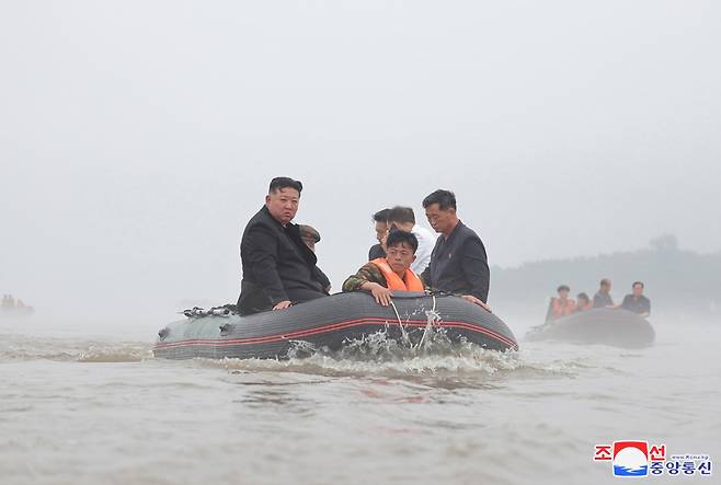 North Korean leader Kim Jong-un (left) inspects flood-hit areas in Sinuiju, North Pyongan Province, in this undated photo provided by the North's official Korean Central News Agency on Wednesay. (Yonhap)