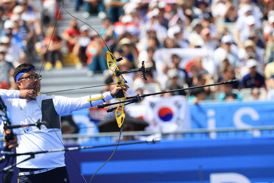 Korea's Kim Woo-jin shoots during the quarterfinals of the men's individual archery contest at the Paris Olympics Sunday, moments before securing his first individual medal at the Games. [NEWS1]