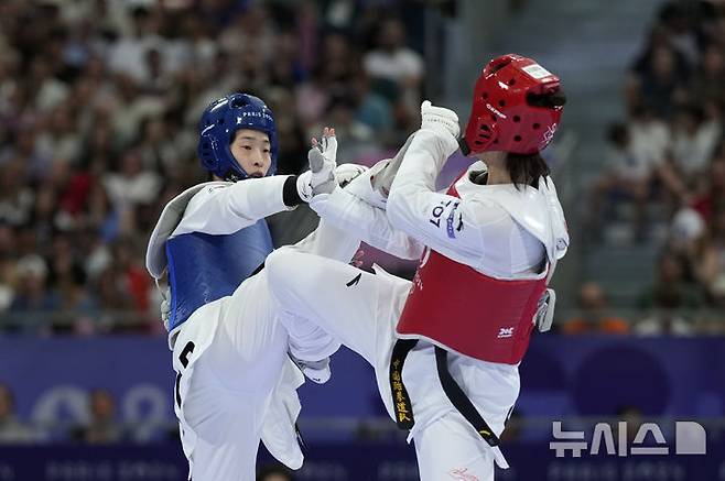 [파리=AP/뉴시스] 이다빈(왼쪽)이 10일(현지시각) 프랑스 파리의 그랑팔레에서 열린 2024 파리올림픽 태권도 여자 67㎏ 초과급 8강전에서 저우쩌치(중국)와 경기하고 있다. 이다빈이 2-1(4-2 3-8 7-6)로 승리하고 4강에 올랐다. 2024.08.10.