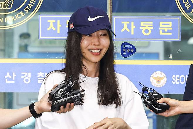 Ador CEO Min Hee-jin speaks to reporters as she exits Yongsan Police Station in Seoul on July 9, following questioning over her alleged breach of trust. (Newsis)