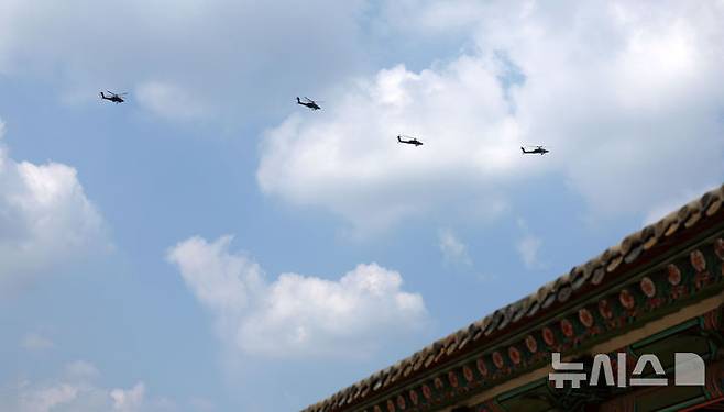 [서울=뉴시스] 김선웅 기자 = 육군 아파치 공격헬기 편대가 14일 서울 종로구 경복궁 일대 상공에서 건군 76주년 국군의 날 행사를 앞두고 연습 비행을 하고 있다. 2024.08.14. mangusta@newsis.com