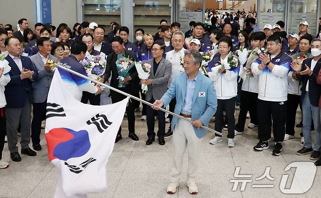 이기흥 대한체육회장이 파리 올림픽을 마치고 13일 인천국제공항을 통해 귀국해 태극기를 흔들고 있다. 대한민국은 2024파리올림픽에서 총 32개의 메달(금 13, 은 9, 동 10)과 종합순위 8위라는 '역대급 성과'를 기록했다.2024.8.13/뉴스1 ⓒ News1 이승배 기자