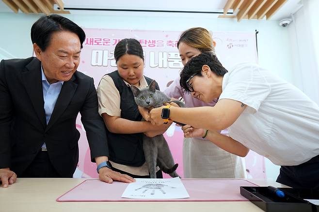 서대문구 내품애센터, 첫 반려동물 입양 '서대문 내품애(愛)센터'에서 입양자와 반려묘의 새 가족 탄생을 축하하는 핸드(풋)프린팅이 진행되고 있다. 이성헌 서대문구청장(왼쪽)도 이 자리에 함께했다. [서대문구 제공. 재판매 및 DB 금지]