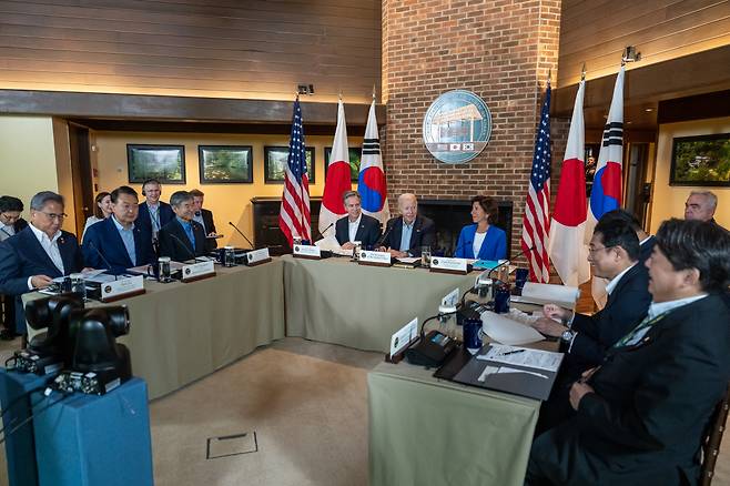 This file photo from August 18, 2023, shows South Korean President Yoon Suk Yeol, US President Joe Biden, and Japanese Prime Minister Fumio Kishida holding a trilateral summit in Laurel Cabin at the Camp David presidential retreat in Maryland. (White House)