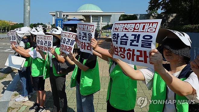 국회 앞 목소리 (서울=연합뉴스) 한종찬 기자 = 전국의대생학부모연맹 관계자들이 16일 오전 국회 앞에서 의학 교육 정상화를 촉구하고 있다. 이날 국회 교육위원회 의학교육소위원회는 보건복지위원회와 '의과대학 교육 점검 연석 청문회'를 열고 2025학년도 1509명 의대 정원 증원이 결정된 과정을 살펴본다. 2024.8.16 saba@yna.co.kr