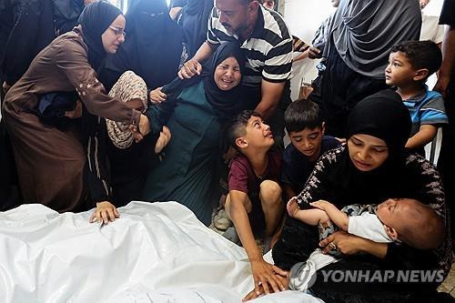 이스라엘군 공습으로 숨진 가족 시신 옆에서 오열하는 팔레스타인 주민 [로이터=연합뉴스]