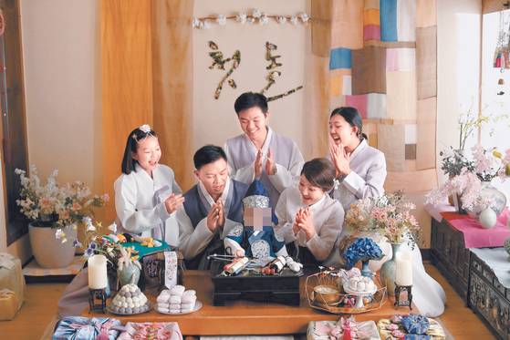 Williamson, second from left, and his wife and children throw a birthday party for a year-old boy who was under their foster care. [LEE SUK]