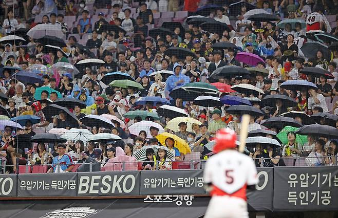 21일 광주 KIA-롯데전에서 KIA 김도영이 타석에 들어선 7회말 무사 1루 비가 내려 관중들이 우산을 쓰고 있다. KIA 타이거즈 제공