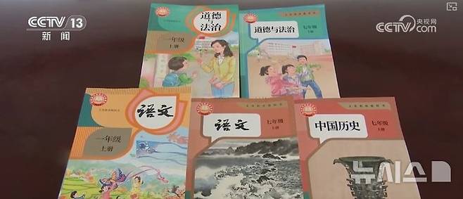 [베이징=뉴시스] 중국 교육부는 올해 가을부터 새로 개정한 도덕과 법치, 중국어, 역사 교과서를 전국 초등학교 1학년생과 중학교 1학년생들에게 사용하고 3년 내에 의무교육 단계의 모든 학년에 적용하기로 했다. 사진은 개정된 교과서.(사진=중국 CCTV 갈무리) 2024.8.28 *DB 및 재배포 금지 photo@newsis.com