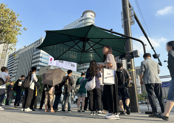 서울 전역에 폭염 경보가 발효된 10일 오후 서울 종로구 세종로 사거리에서 시민들이 그늘막 아래에서 더위를 피하며 신호를 기다리고 있다. 〈사진=연합뉴스〉