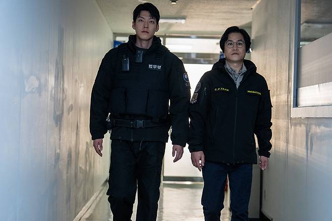 Kim Sung-kyun (right) and Kim Woo-bin in “Officer Black Belt.” (Netflix)