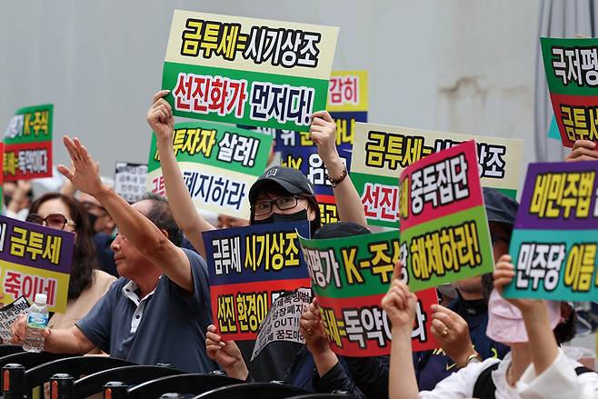 한국주식투자자연합회(한투연) 회원들이 2024년 5월30일 서울 영등포구 더불어민주당 당사 앞에서 금융투자소득세(금투세) 폐지 촉구 집회를 열고 구호를 외치고 있다. ⓒ연합뉴스