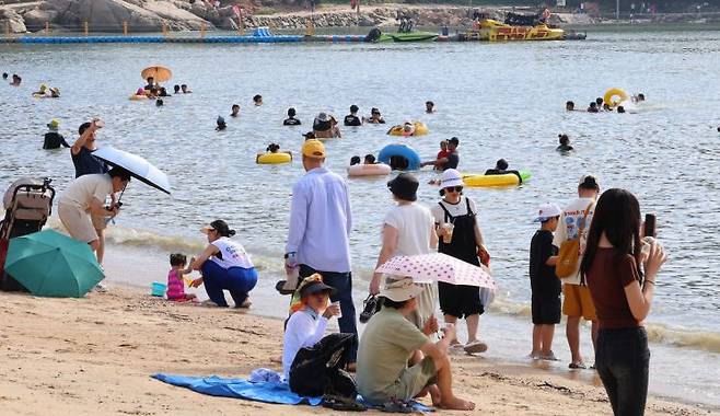 폭염경보가 발효된 18일 오후 인천 중구 을왕리해수욕장을 찾은 시민들이 더위를 식히고 있다. [이미지출처=연합뉴스]