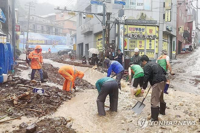 많은 비 쏟아진 울릉도 (울릉=연합뉴스) 11일부터 12일까지 경북 울릉에 300㎜가 넘는 비가 내린 가운데 12일 오후 울릉 주요 도로에 빗물과 함께 토사가 흘러내리고 있다.
    울릉군 공무원들은 주민과 함께 추가 피해를 막기 위해 토사를 치우고 있다. 2024.9.12 [울릉군 제공 동영상 캡처. 재판매 및 DB 금지] sds123@yna.co.kr