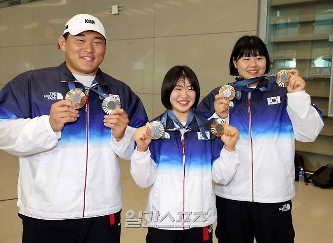 대한민국 유도대표팀 선수들이 2024 파리올림픽을 마치고 5일 오후 인천국제공항을 통해 귀국했다. 대표팀 김민종, 허미미, 김하윤이 입국장에서 메달을 들고 포즈를 취하고 있다. 유도대표팀은 이번 파리올림픽에서 개인전 은메달 2개(남자 100㎏ 이상급 김민종, 여자 57㎏급 허미미)와 동메달 2개(남자 81㎏급 이준환, 여자 78㎏ 이상급 김하윤)를, 혼성단체전에서 동메달을 획득하며 메달 5개를 따내는 성적을 거뒀다. 인천공항=김민규 기자 mgkim1@edaily.co.kr /2024.08.05/