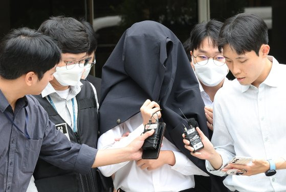 의료계 집단행동에 동참하지 않은 의사·의대생의 신상 정보가 담긴 블랙리스트 '감사한 의사'를 유포한 사직 전공의 정모씨가 20일 서울 서초구 서울중앙지법에서 열린 구속 전 피의자 심문(영장실질심사)을 마친 뒤 경찰과 함께 이동하고 있다. 뉴스1