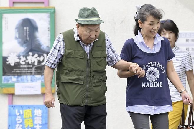 강제 자백과 조작된 증거에 근거한 살인 유죄 판결을 받은 후 거의 60년 동안 사형수 생활을 해온 88세의 전직 복서 이와오 하카마다(왼쪽)가 25일 일본 시즈오카현 하마마쓰에서 지지자의 도움을 받으며 산책을 하고 있다. 시즈오카=AP 뉴시스