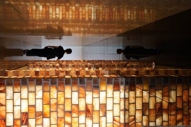 A visitor walks through the Rainbow Healing Center's relaxation zone featuring an illite-covered sauna. (Lee Si-jin/The Korea Herald)