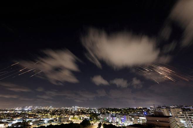 Israel's Iron Dome anti-missile system intercepts ballistic missiles fired by Iran as seen from Ashkelon, Israel, on Tuesday. [REUTERS/YONHAP]