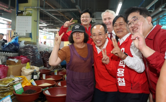 여 원내대표도 강화군수 한 표 호소 - 10·16 인천 강화군수 보궐선거 공식 선거 운동이 시작된 3일 추경호(앞줄 왼쪽 두 번째) 국민의힘 원내대표가 강화풍물시장을 찾아 지지를 호소하며 시민들과 사진을 찍고 있다. 뉴스1