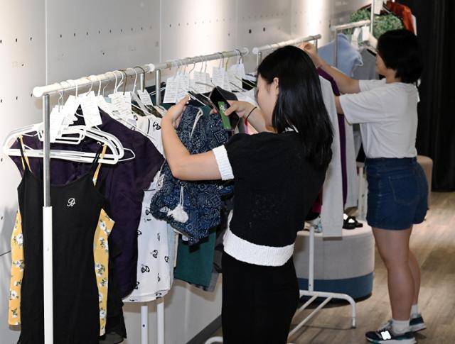 지난달 25일 오후 서울 마포구 서강대 로욜라도서관 내 이주연갤러리에서 열린 옷 교환 파티에서 학생들이 옷을 구경하고 있다. 홍인기 기자