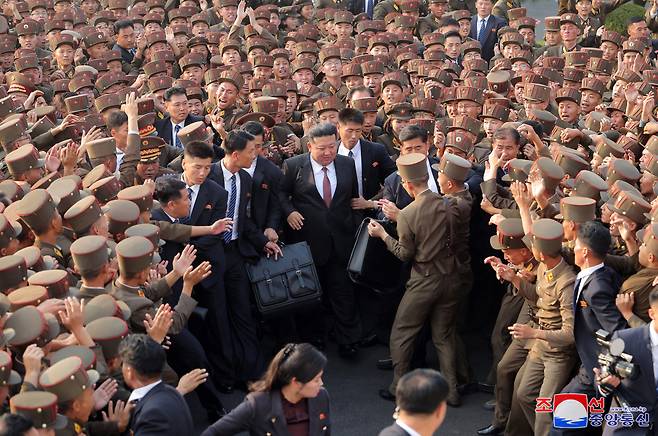 North Korean leader Kim Jong-un (center) is seen surrounded by the crowd as he visited Kim Jong-un University of National Defense in Pyongyang on Monday. (KCNA-Yonhap)