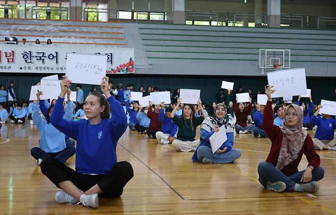 Seventy foreign students in a beginner Korean class participate in the Dictation Golden Bell at the gymnasium of Keimyung University in Daegu on Tuesday, a day ahead of Hangeul Day. (Yonhap)