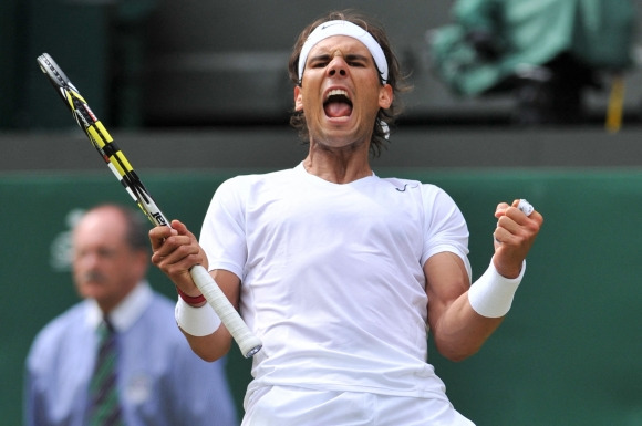 FILES-TENNIS-ESP-NADAL - (FILES) Spain‘s Rafael Nadal celebrates beating Czech Republic’s Lukas Rosol during their men‘s singles second round match on day four of the 2014 Wimbledon Championships at The All England Tennis Club in Wimbledon, southwest London, on June 26, 2014. Nadal won 4-6, 7-6, 6-4, 6-4. Rafael Nadal announced on October 10, 2024 he will retire from professional tennis after the Davis Cup finals in November, ending a career in which he won 22 Grand Slam titles and Olympic singles gold. (Photo by GLYN KIRK / AFP)    <Copyright (c) Yonhap News Agency prohibits its content from being redistributed or reprinted without consent, and forbids the content from being learned and used by artificial intelligence systems.>