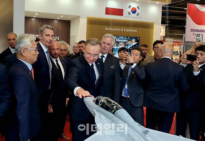 안제이 두다 폴란드 대통령(중앙)이 지난 9월 3일(현지시각) 키엘체에서 열린 국제방산전시회(MSPO)에서 KAI 부스를 찾아 윤종호 KAI 부사장(왼쪽)으로부터 설명을 듣다 폴란드 군에 도입된 FA-50 모형을 쓰다듬고 있다. (사진=KAI)