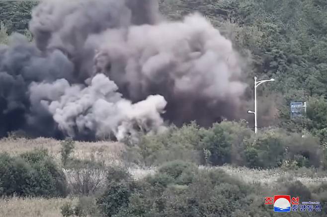 This photo, provided by North Korea's official Korean Central News Agency on Thursday, shows the North's blowing up of part of the Donghae Line road along the east coast on Tuesday. (Yonhap)