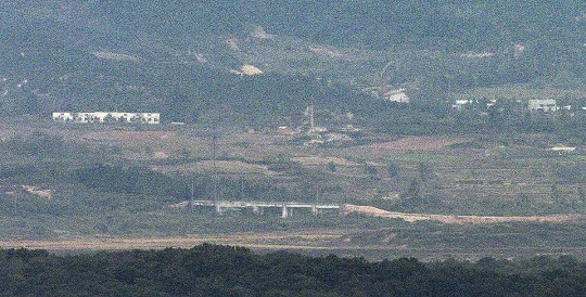 북한이 경의선과 동해선 도로 폭파를 준비하는 정황이 우리 군 감시장비에 포착된 가운데 14일 경기도 파주시 접경지역에서 바라본 서부전선 비무장지대(DMZ) 북측 지역의 경의선 도로 위 구조물 인근에 흙더미가 쌓여 있다. 연합뉴스