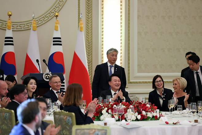 Attendees of a state dinner hosted by President Yoon Suk Yeol (center) clap hands during the event held at Cheong Wa Dae on Thursday. (Presidential office)