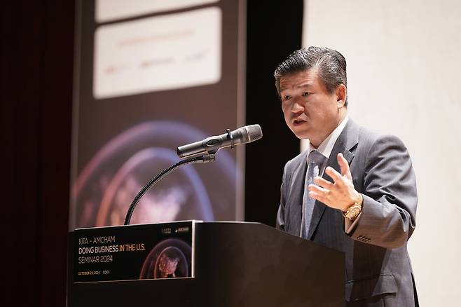 AmCham Chairman & CEO James Kim delivers opening remarks at the sixth annual business seminar held in Seoul on Tuesday. (AmCham)