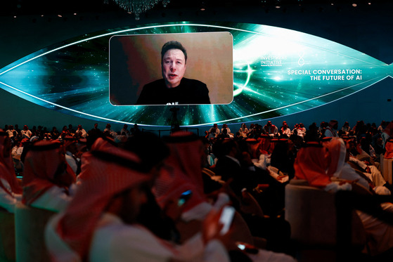 Tesla CEO Elon Musk appears on a screen during the Future Investment Initiative in Riyadh, Saudi Arabia, on Tuesday. [REUTERS/YONHAP]