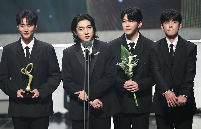 Sungjin of rock band DAY6, second from left, speaks after receiving the Minister of Culture, Sports and Tourism Commendation during the Korea Popular Culture and Arts Awards at the National Theater's Haeoreum Grand Theater in Jung District, central Seoul, on Thursday evening. [NEWS1]