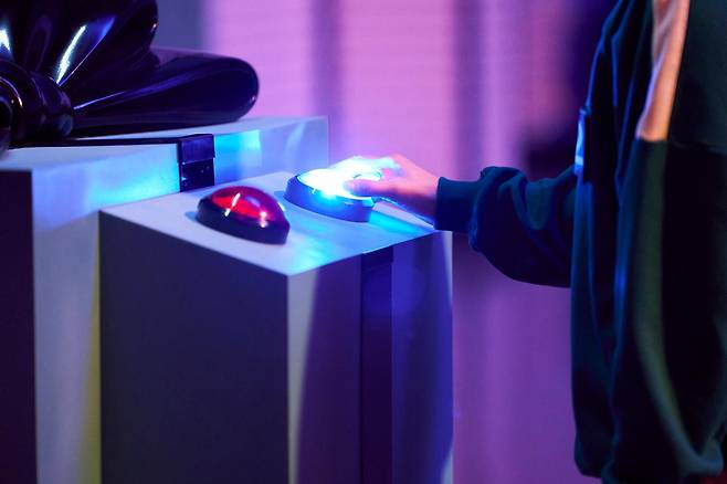 A participant makes a choice to stay or opt out of the games in "Squid Game 2." (Netflix)