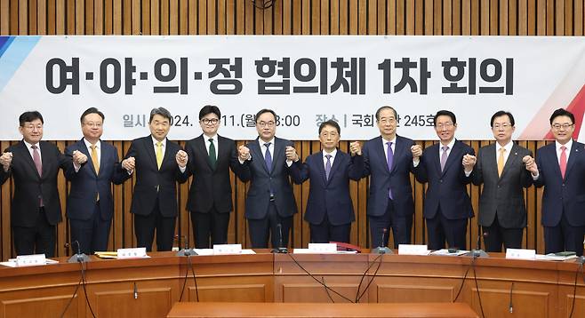 한동훈(왼쪽 네번째) 국민의힘 대표와 한덕수(오른쪽 네번째) 국무총리, 이진우(가운데) 대한의학회장 등이 11일 국회에서 열린 ‘여야의정 협의체’ 1차 회의에서 카메라를 향해 포즈를 취하고 있다. [연합]