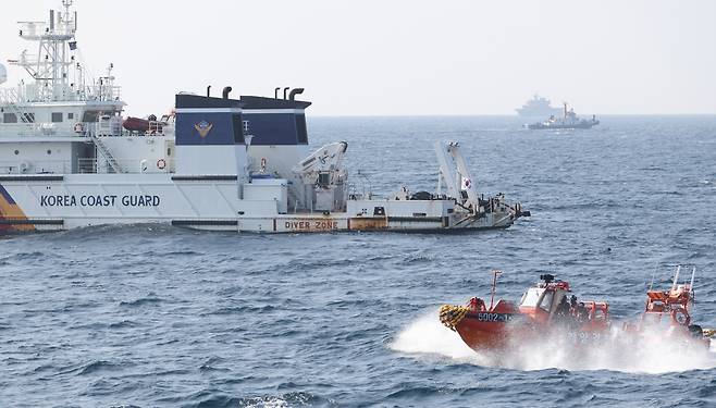 The Coast Guard on Wednesday searches for missing crew members from a fishing boat that sank off Jeju Island. (Yonhap)