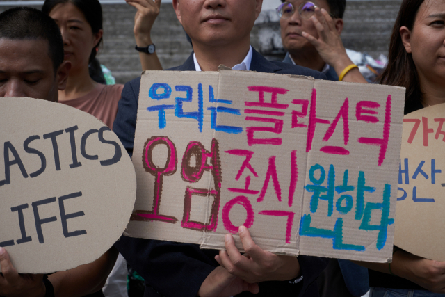 지난 9월 11일 오전 서울 종로구 세종문화회관에서 ‘플뿌리연대’가 정부의 강력한 플라스틱 규제 협약 참여와 국제협약 도출을 요구하는 퍼포먼스를 하고 있다. [플뿌리연대 제공]