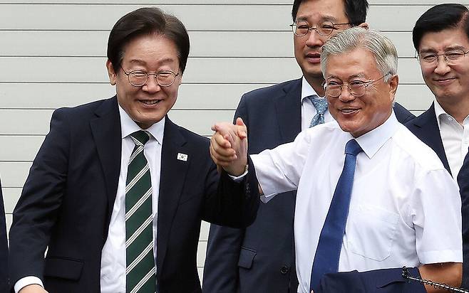 문재인 전 대통령과 이재명 더불어민주당 대표가 지난 9월8일 오후 경남 양산시 하북면 평산마을 문 전 대통령 사저 앞에서 손을 맞잡고 인사하고 있다. 김경호 선임기자 jijae@hani.co.kr