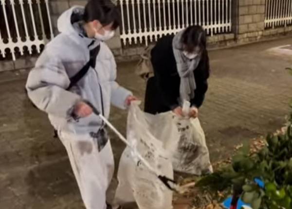 여의도 국회 앞 도로에서 집회가 끝난 뒤 자발적으로 쓰레기를 치우던 여성들의 모습이 포착됐다. 사진은 여성들이 집회 거리를 청소하는 모습. /사진=유튜브 '뉴탐사' 캡처