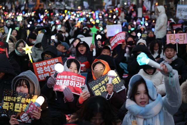 내란죄 피의자 윤석열 대통령 탄핵안 표결을 하루 앞둔 13일 저녁 서울 여의도 국회 앞에서 ‘내란범 윤석열 탄핵 전국 긴급행동’ 집회가 열려 응원봉과 손팻말을 든 참가자들이 탄핵을 외치고 있다. 김영원 기자 forever@hani.co.kr