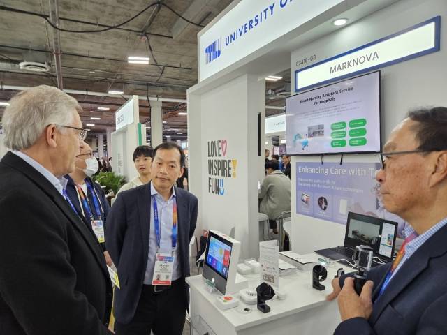 마크노바의 최혁 대표(가운데)가 미국 라스베이거스에서 열리는 세계 최대 정보기술(IT)·가전 전시회 'CES 2025'에서 시니어 케어 서비스를 위한 ‘A-ONE Care(에이원케어)’를 설명하고 있다. (사진제공=마크노바)